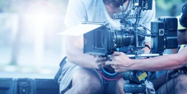 Professionals operating cinematography equipment