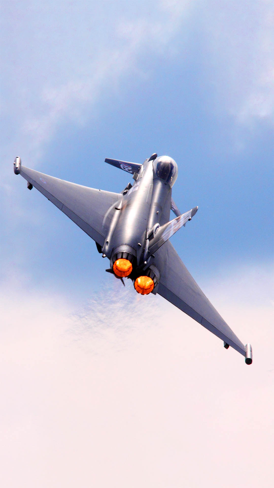 Image featuring jet rising through the sky with its afterburner activated